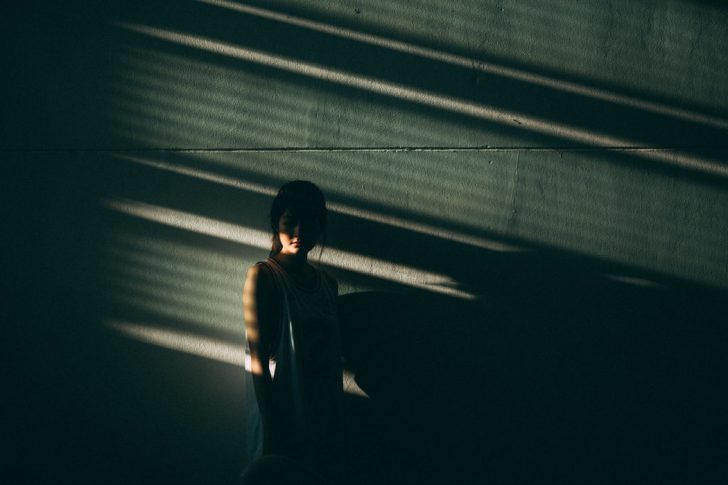 woman covered in shadows